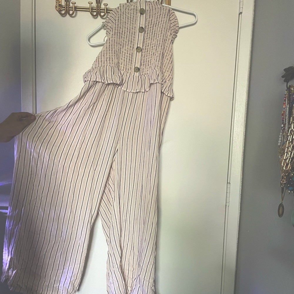 Sleeveless tube top jumpsuit. Pin stripes. Button details. Wide legs.